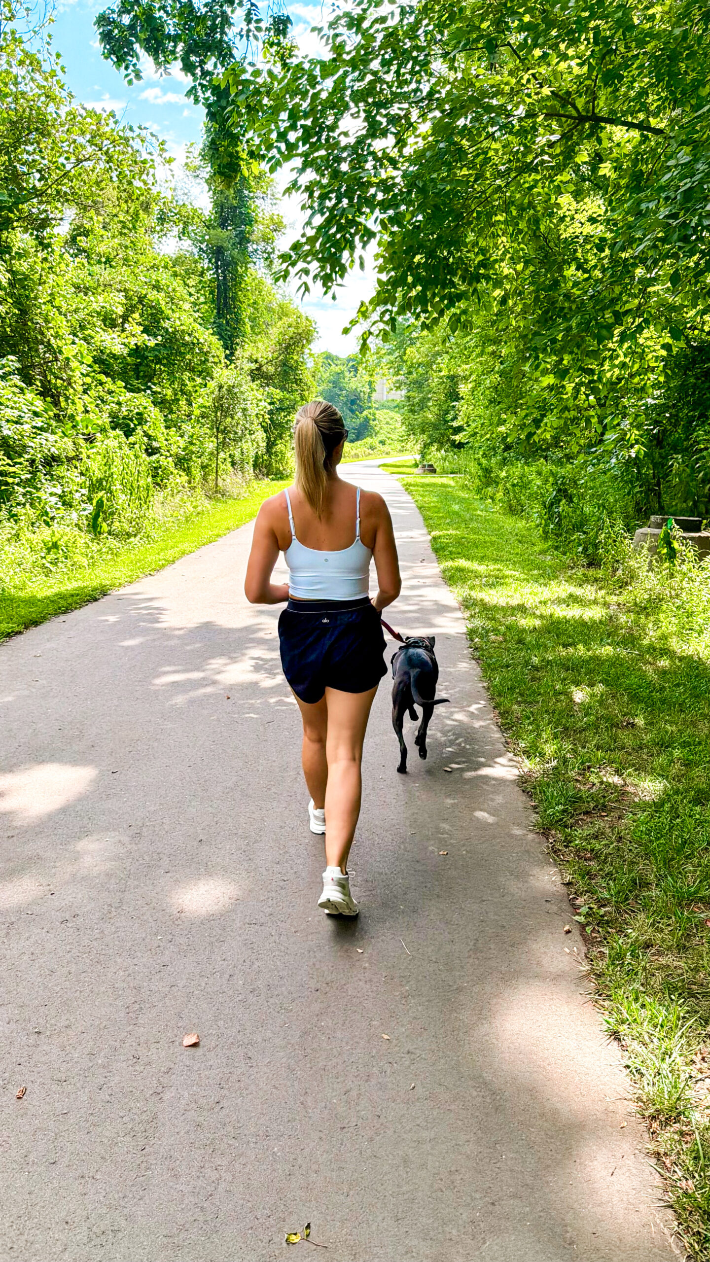 Steph Berry walking her dog Captain outdoors as part of her daily movement routine